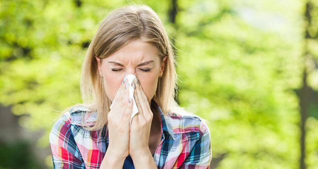 Woman sneezes