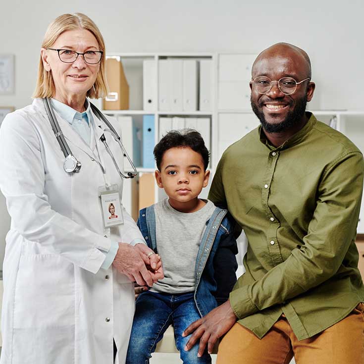 A doctor, father and son in the exam room